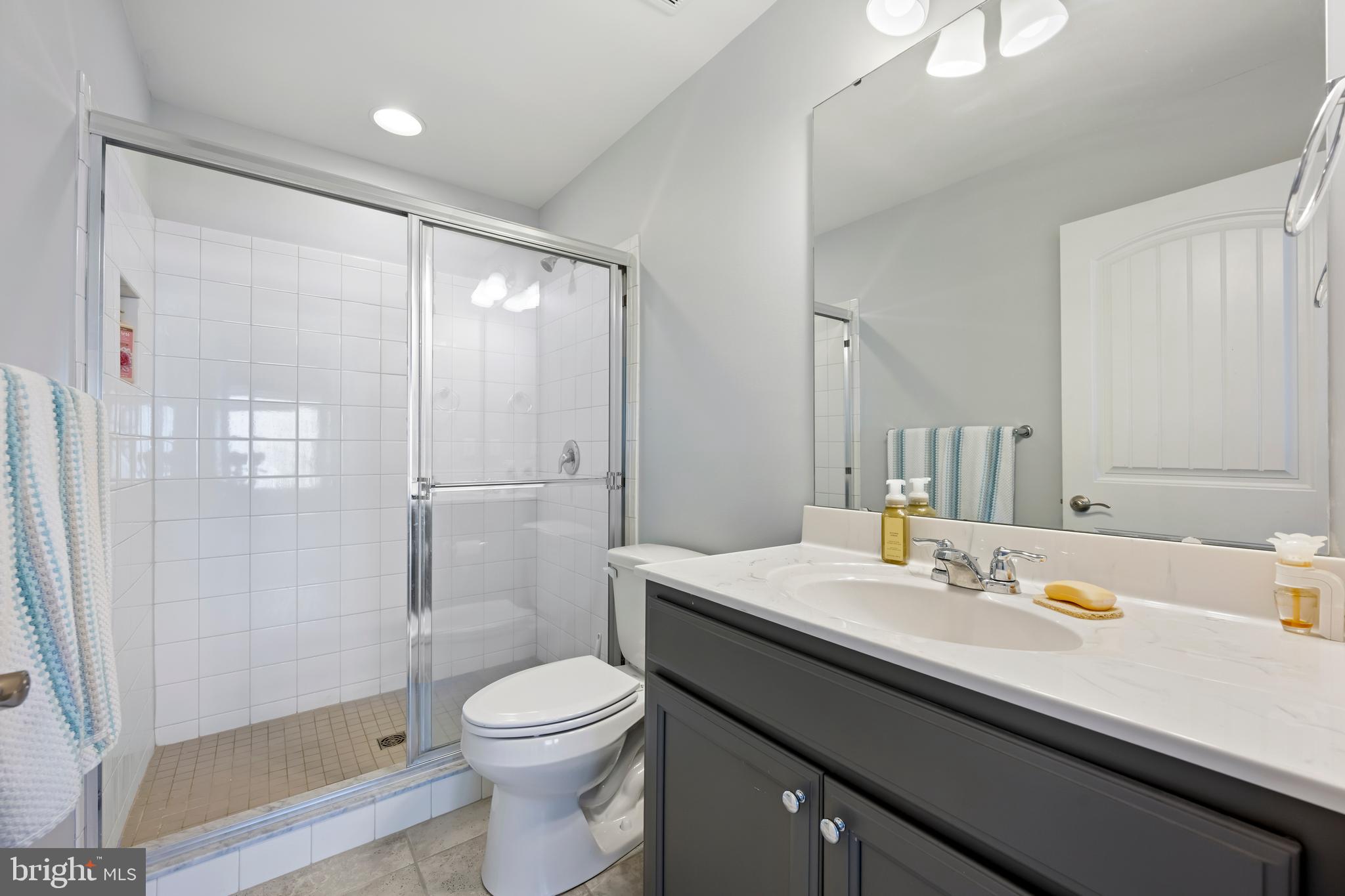 34017 Smiths Point Lane Lewes, DE 19958 - Photo 34 of 66 a bathroom with a sink a toilet and shower