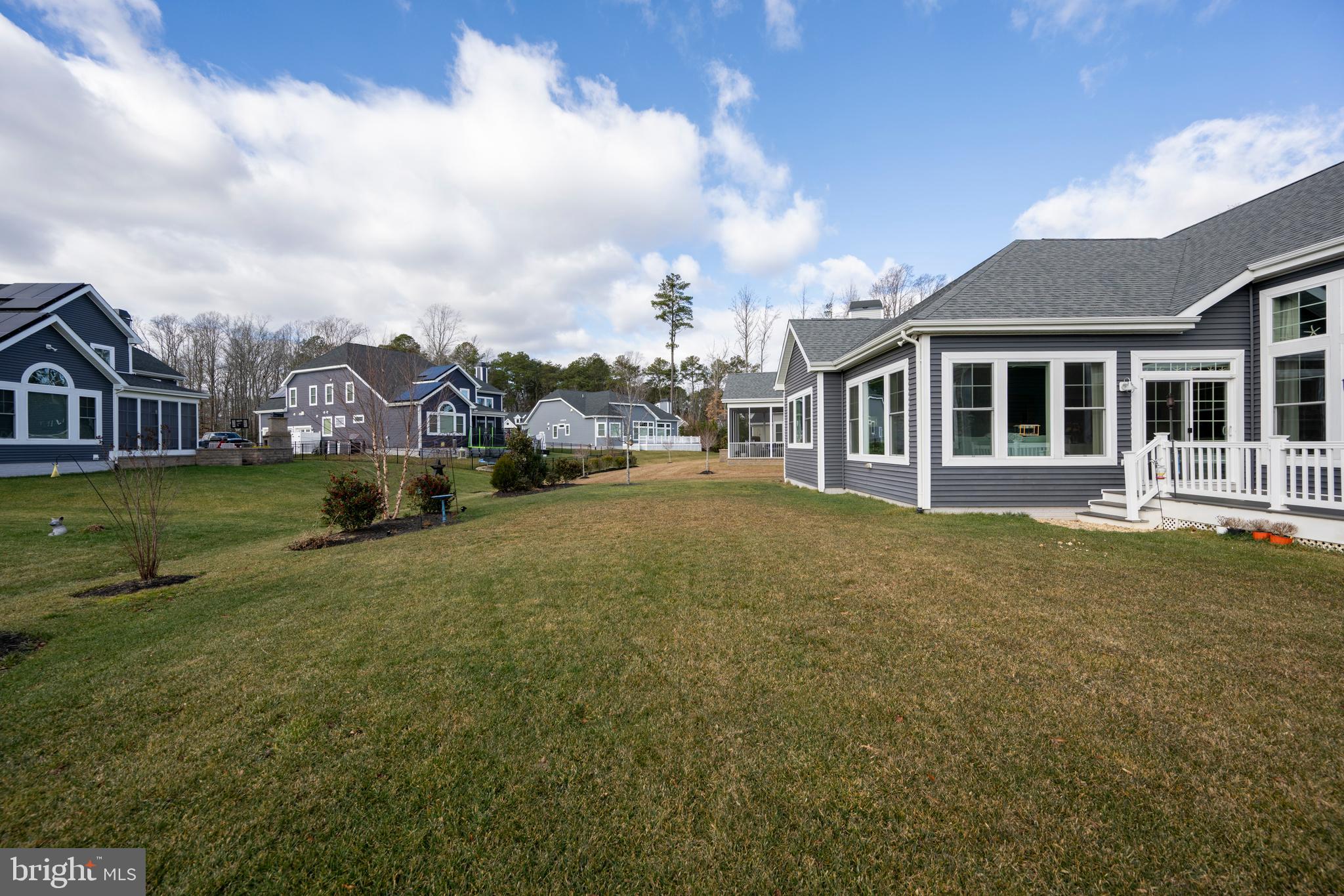 34017 Smiths Point Lane Lewes, DE 19958 - Photo 46 of 66 a view of a house with a big yard and potted plants