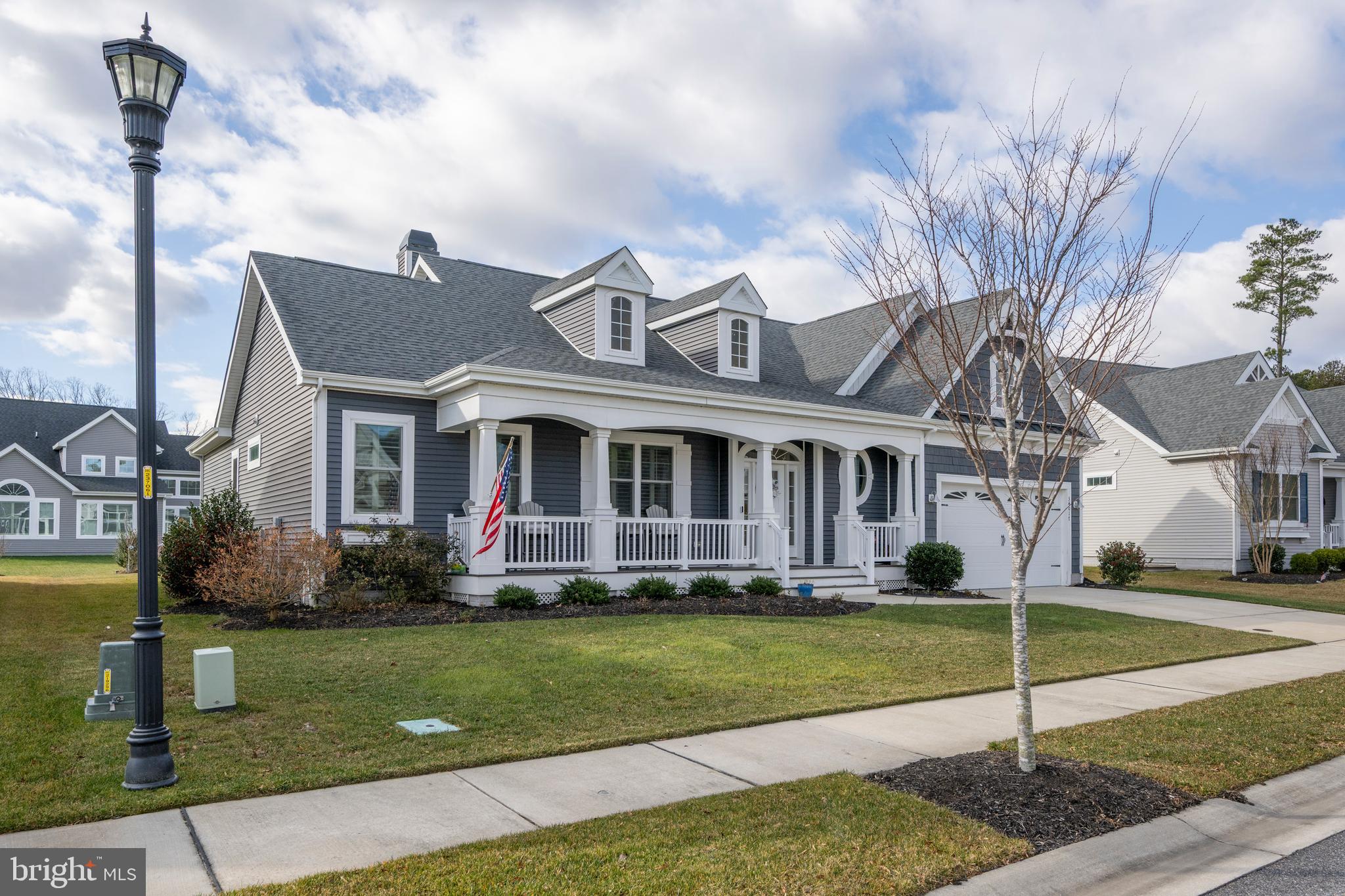 34017 Smiths Point Lane Lewes, DE 19958 - Photo 6 of 66 a front view of a house with a yard
