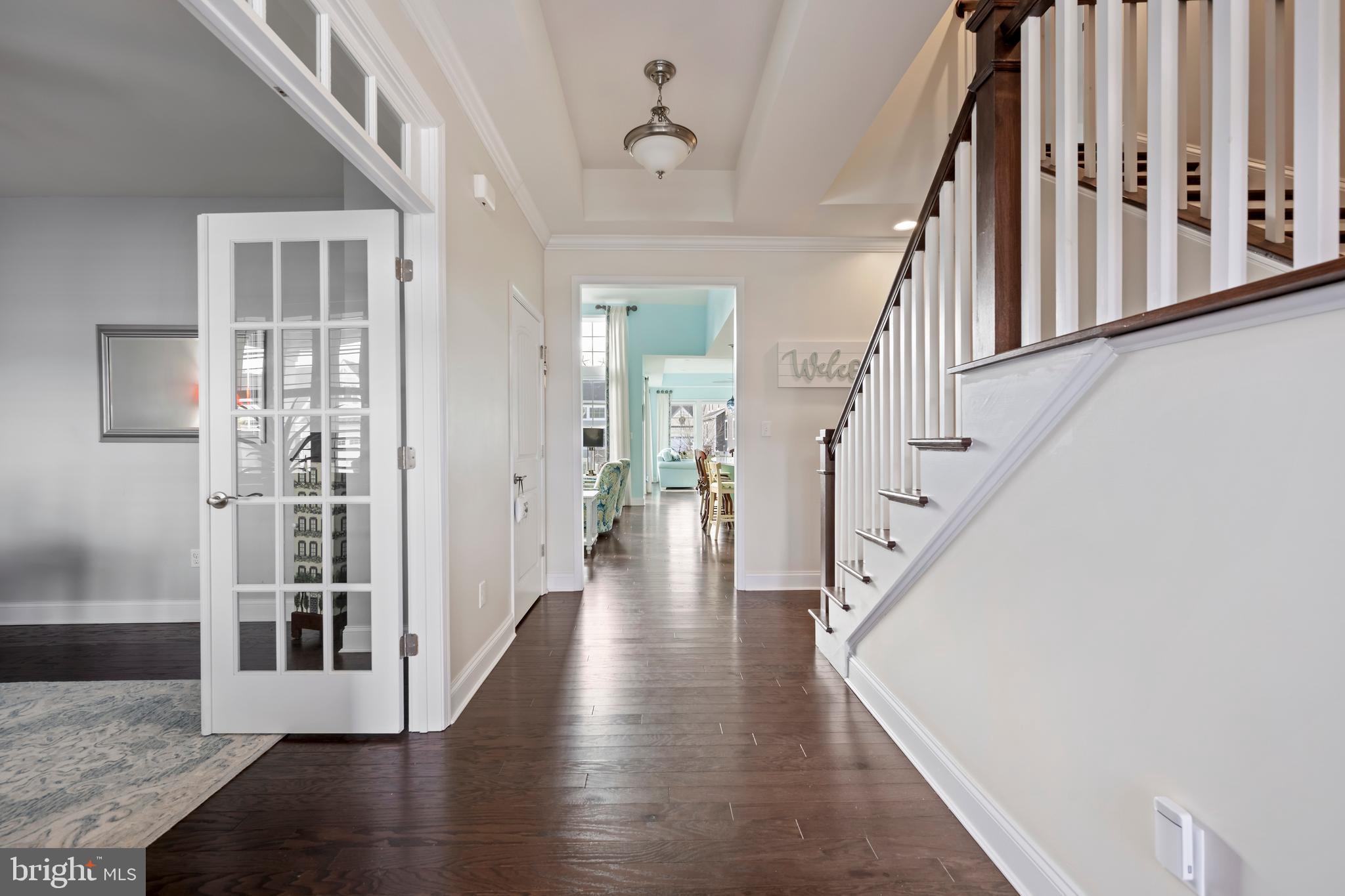 34017 Smiths Point Lane Lewes, DE 19958 - Photo 8 of 66 a view of a hallway with wooden floor and staircase