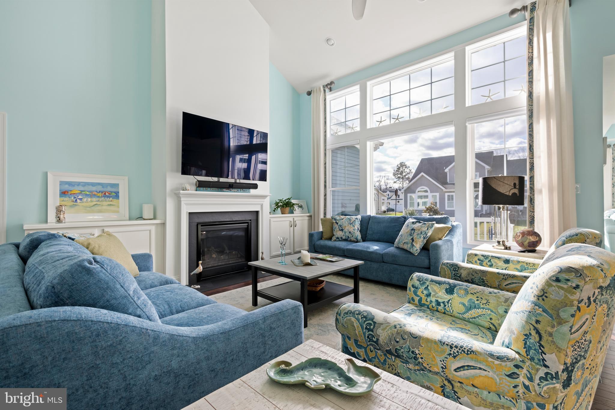 34017 Smiths Point Lane Lewes, DE 19958 - Photo 10 of 66 a living room with furniture a flat screen tv and a fireplace