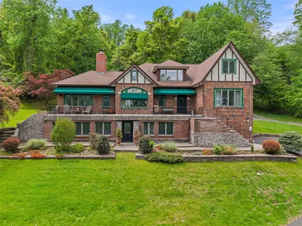 a front view of house with yard and green space