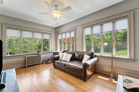 a dining room with furniture and a floor to ceiling window