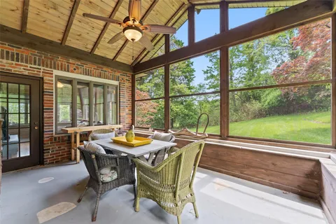 a view of a dining room with furniture and window