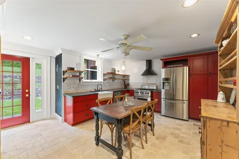 a view of a dining room with furniture and chandelier