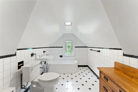 a front view of a house with a garden and swimming pool