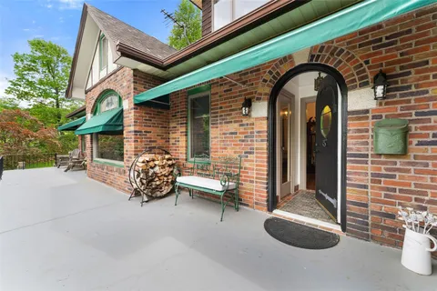 a view of a hallway with wooden floor and a livingroom