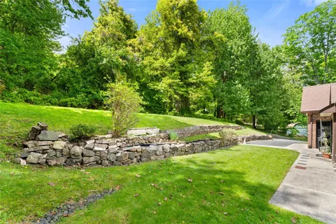 a view of a white house with a yard and porch
