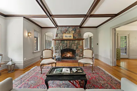 a living room with furniture a fireplace and a table