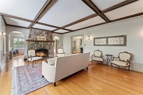 a living room with furniture a fireplace and a table