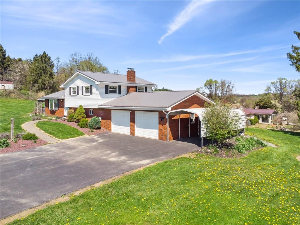 a front view of a house with a garden and deck