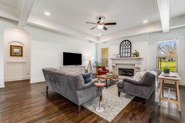 a view of a livingroom with furniture and a flat screen tv