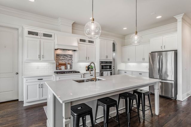 a kitchen with a sink stove and refrigerator