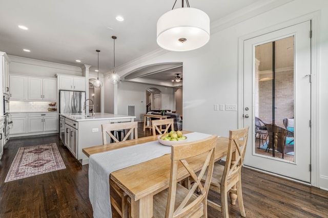 a living room with furniture a window and a potted plant