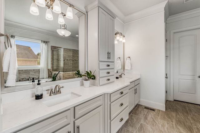 a bathroom with a bathtub a shower and a window