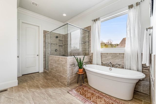 a view of walk in closet with clothes