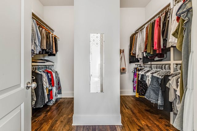 a bedroom with bed and a chandelier