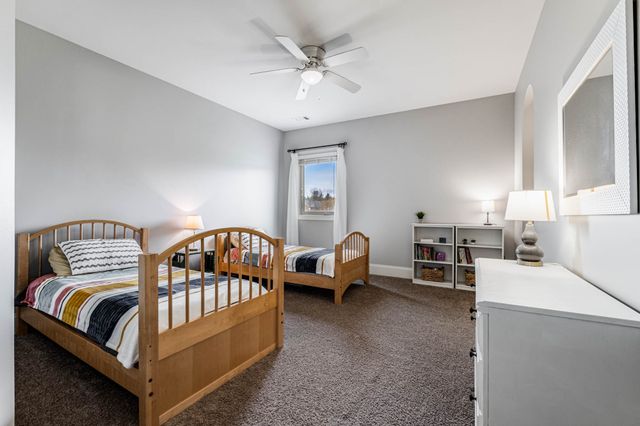 a view of walk in closet with clothes
