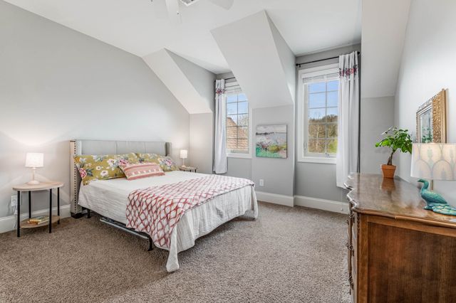 a bathroom with a granite countertop sink a toilet a mirror a bathtub and shower