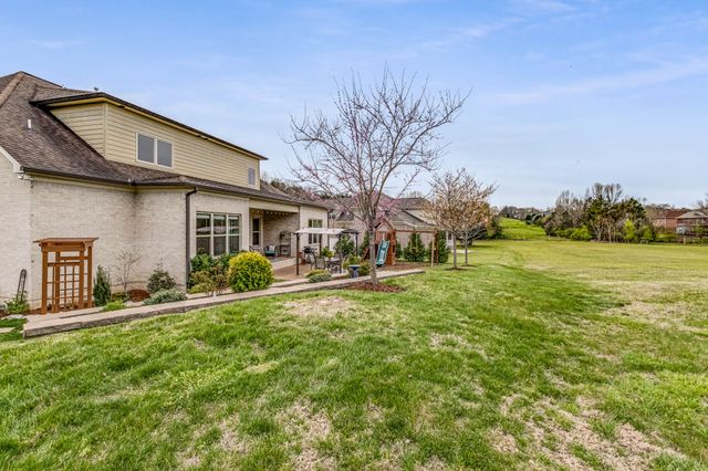 an aerial view of a house with swimming pool and mountains