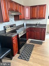 1414 West Tioga Street, Unit 2F Philadelphia, PA 19140 - Photo 3 of 8 a kitchen with a sink a stove and cabinets