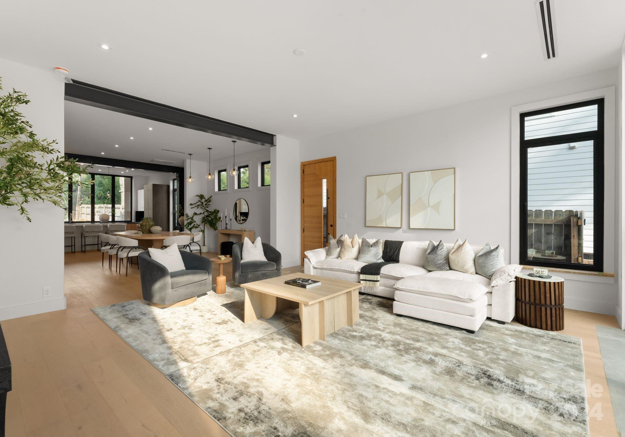 237 Marsh Road, Unit 101 Charlotte, NC 28209 - Photo 25 of 48 a living room with couches and large windows