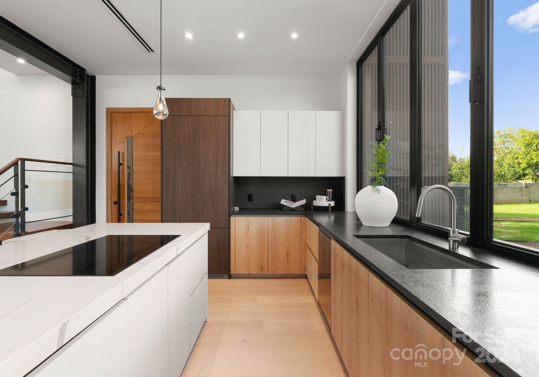 237 Marsh Road, Unit 101 Charlotte, NC 28209 - Photo 39 of 48 a kitchen with stainless steel appliances granite countertop a sink a stove and a refrigerator