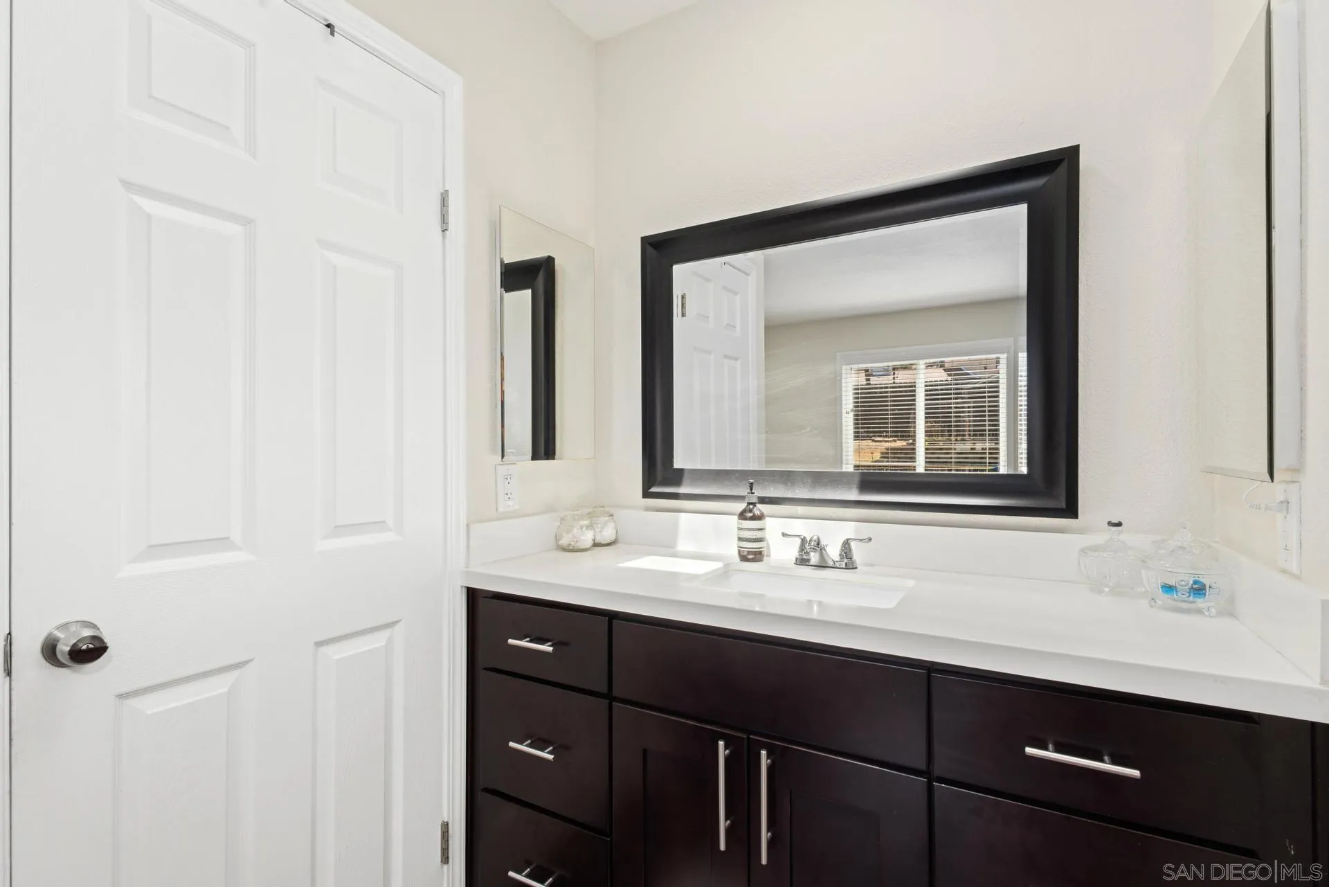 346 El Monte Road El Cajon, CA 92020 - Photo 16 of 24 a bathroom with a double vanity sink and a mirror