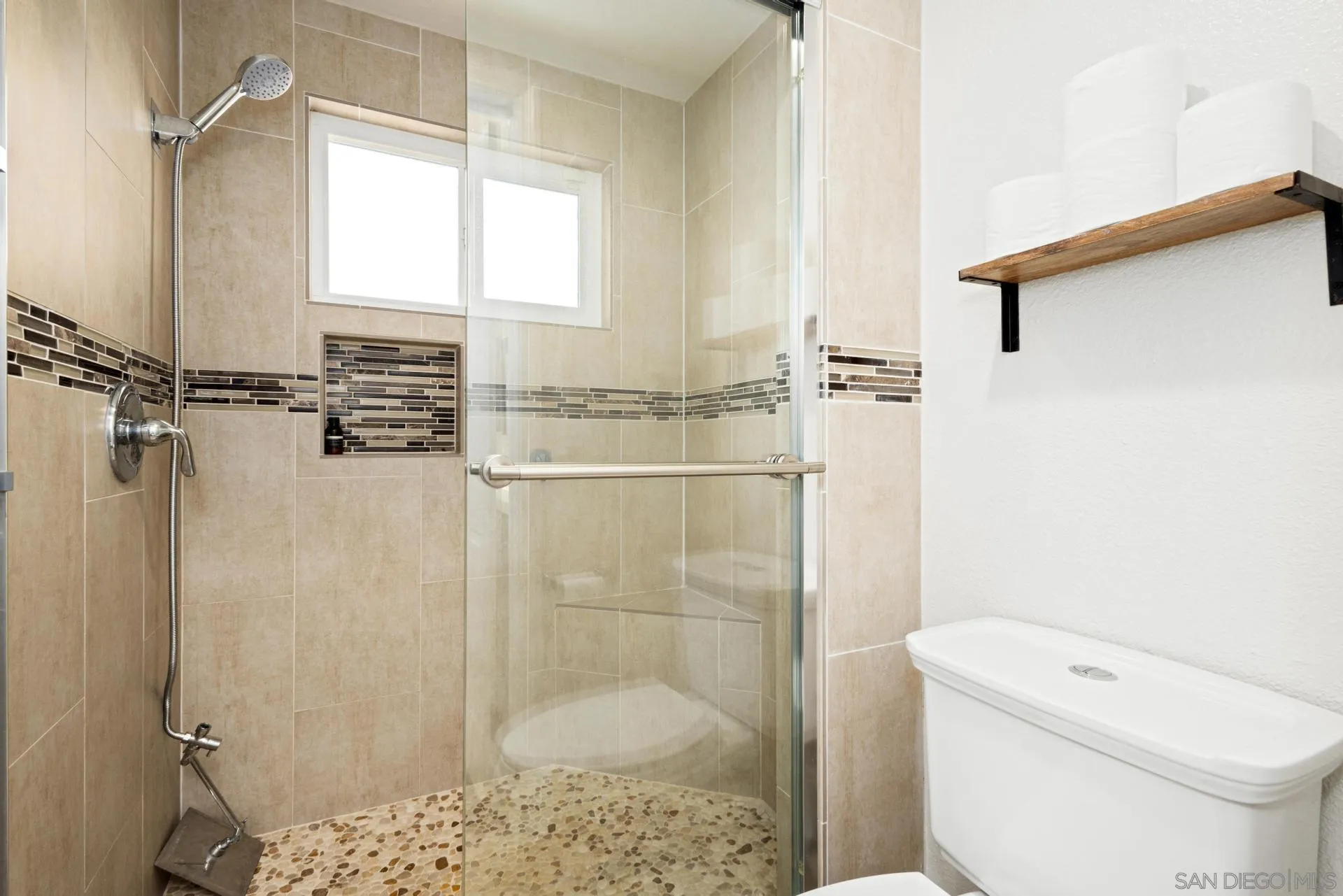 346 El Monte Road El Cajon, CA 92020 - Photo 17 of 24 a bathroom with a shower a toilet and a window
