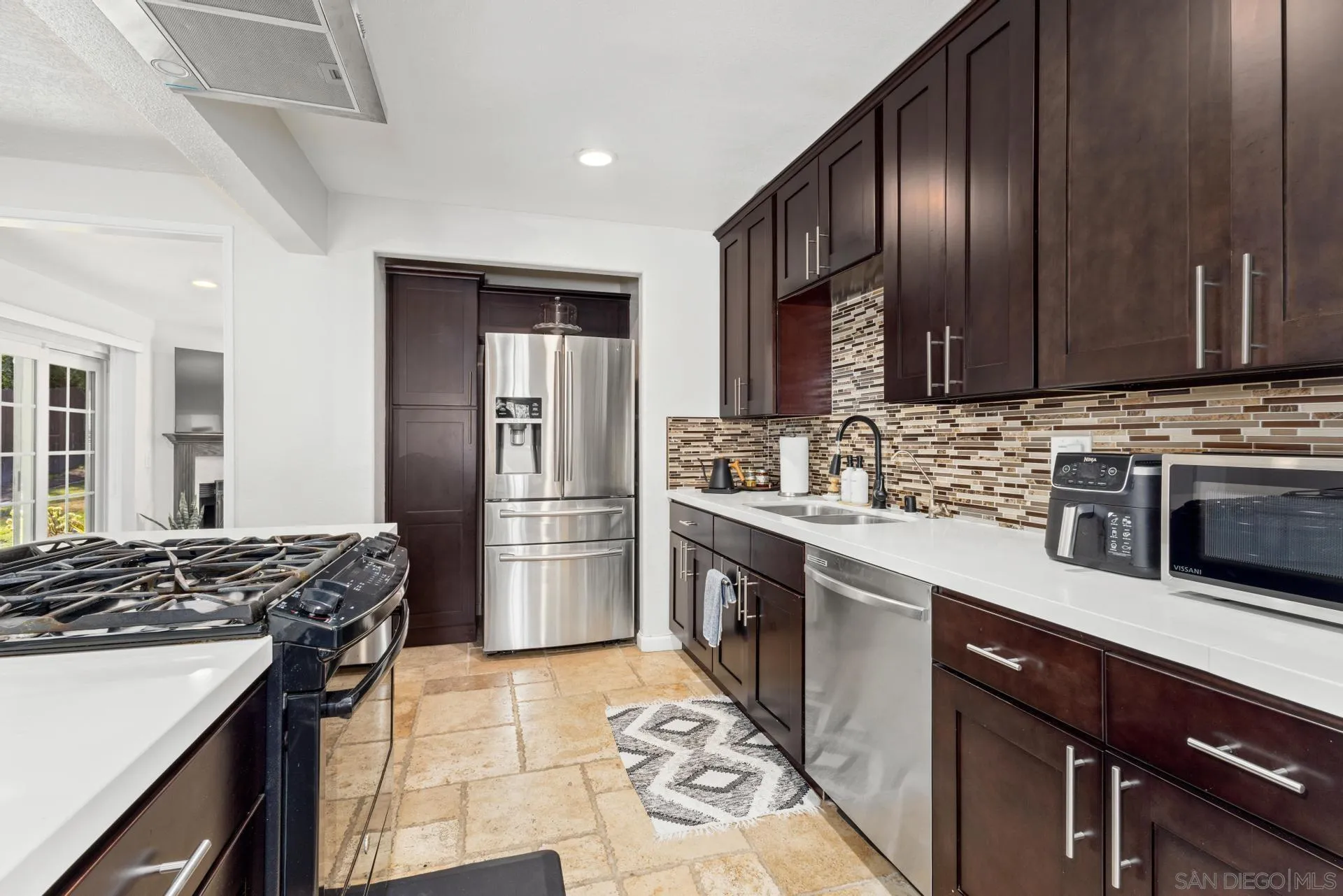 346 El Monte Road El Cajon, CA 92020 - Photo 6 of 24 a kitchen with stainless steel appliances granite countertop a sink stove and refrigerator