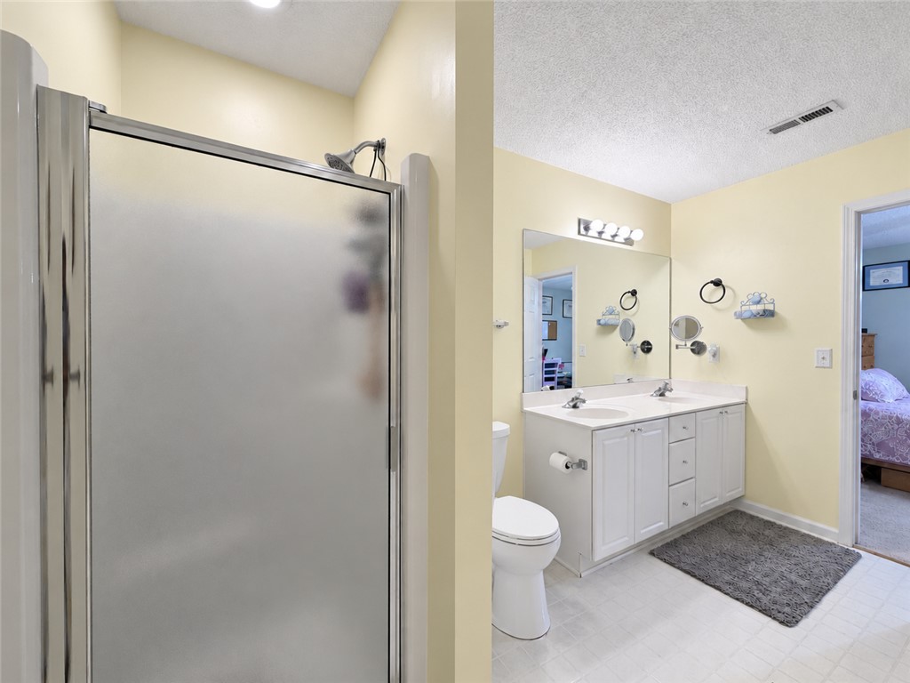 113 Grand Oak Circle Pendleton, SC 29670 - Photo 15 of 25 Functional bathroom design incorporates a double vanity alongside a private walk-in shower stall.