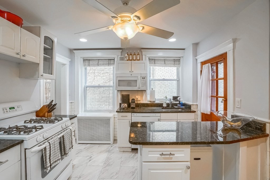 22 James Street, Unit 1 Brookline, MA 02446 - Photo 11 of 24 a kitchen with stainless steel appliances granite countertop a stove and a sink