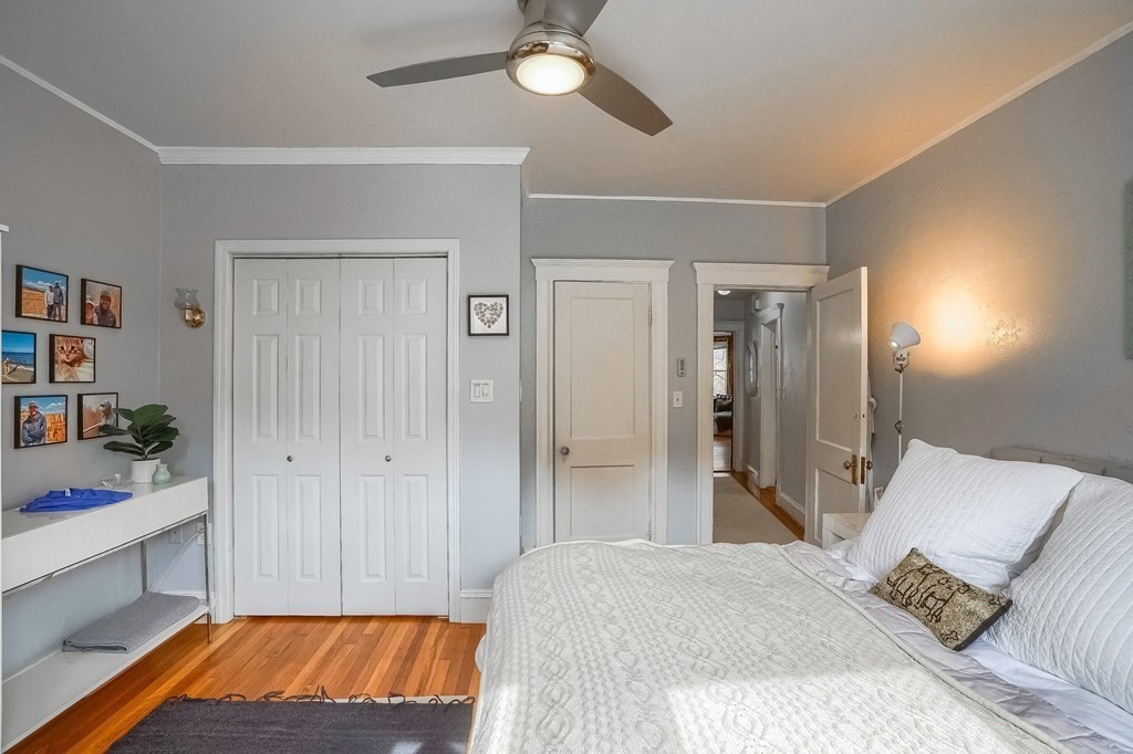 22 James Street, Unit 1 Brookline, MA 02446 - Photo 15 of 24 a bedroom with a bed and a chandelier