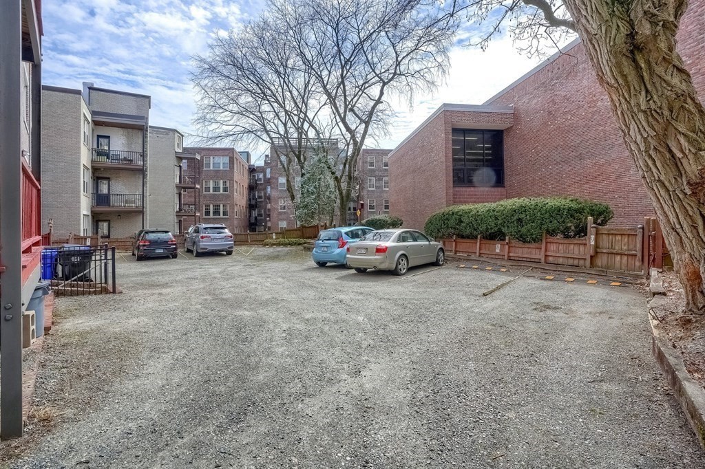 22 James Street, Unit 1 Brookline, MA 02446 - Photo 22 of 24 a car parked in front of brick building