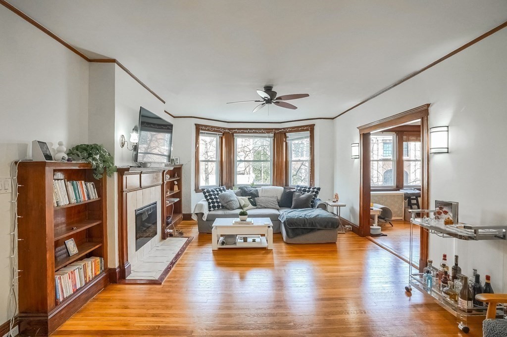 22 James Street, Unit 1 Brookline, MA 02446 - Photo 5 of 24 a living room with fireplace furniture and a wooden floor