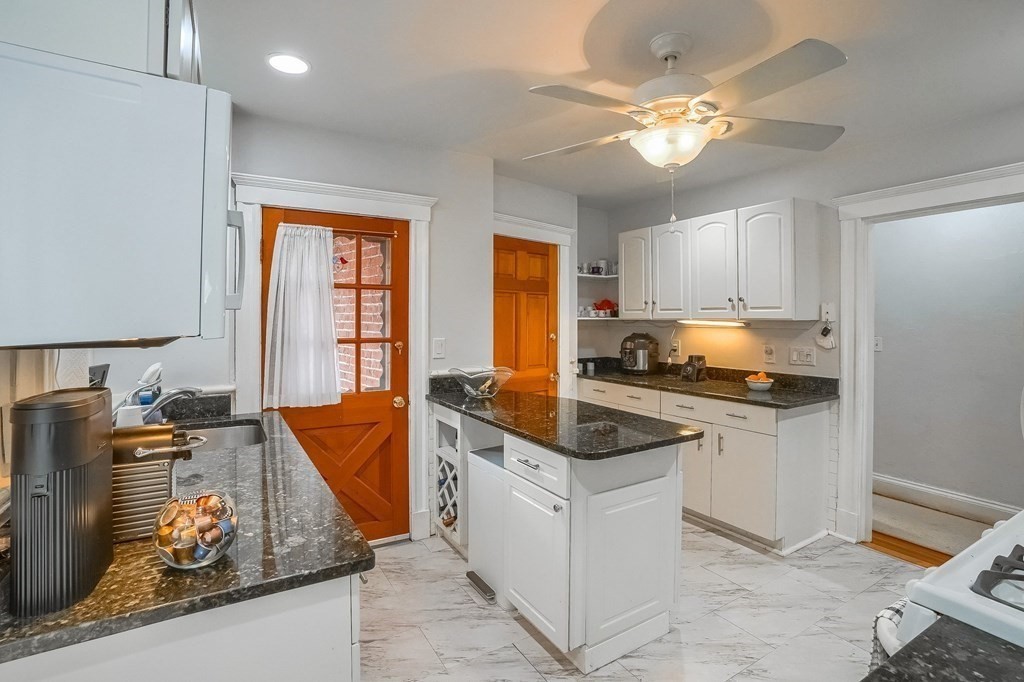 22 James Street, Unit 1 Brookline, MA 02446 - Photo 7 of 24 a kitchen with stainless steel appliances granite countertop a sink stove and refrigerator