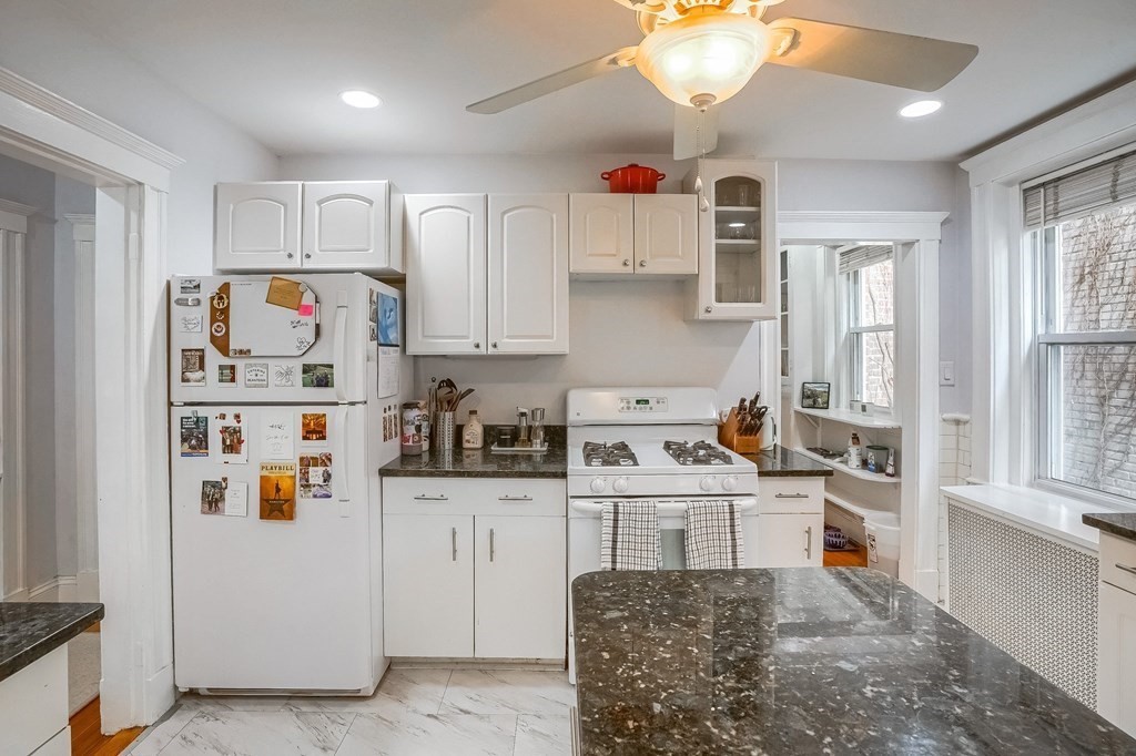 22 James Street, Unit 1 Brookline, MA 02446 - Photo 10 of 24 a kitchen with stainless steel appliances granite countertop a refrigerator and a sink