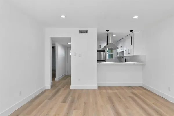 a view of a kitchen with refrigerator and sink