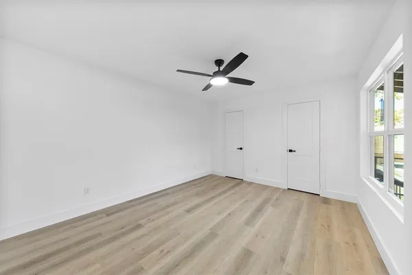 wooden floor in an empty room with a window