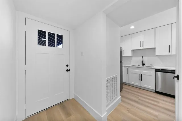 a kitchen with white cabinets and white appliances