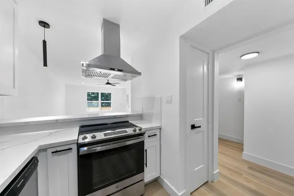 a kitchen with stainless steel appliances a stove and a refrigerator