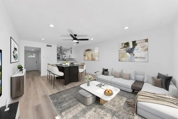 a living room with furniture and wooden floor