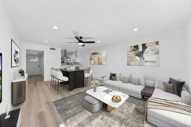a living room with furniture and wooden floor