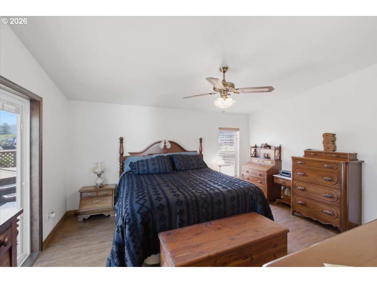 35377 Ede Road Lebanon, OR 97355 - Photo 17 of 48 a bedroom with a bed and a chandelier
