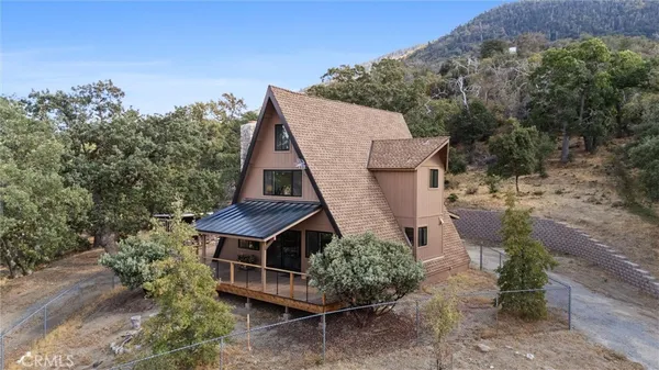 an aerial view of a house with a yard and balcony