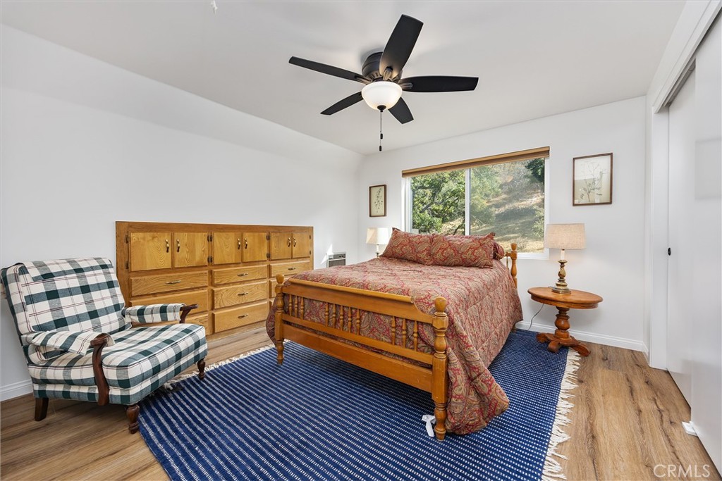 28207 Oaks Rancho Road Keene, CA 93531 - Photo 22 of 48 a bedroom with a bed wooden floor and window