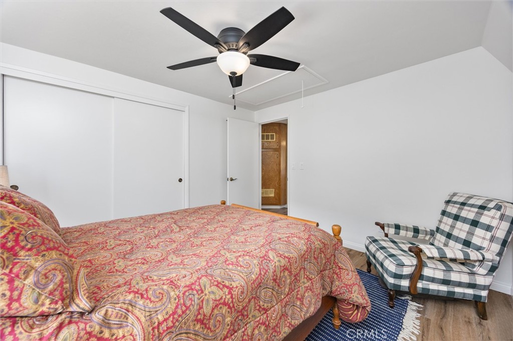 28207 Oaks Rancho Road Keene, CA 93531 - Photo 23 of 48 a bedroom with a bed and wooden floor