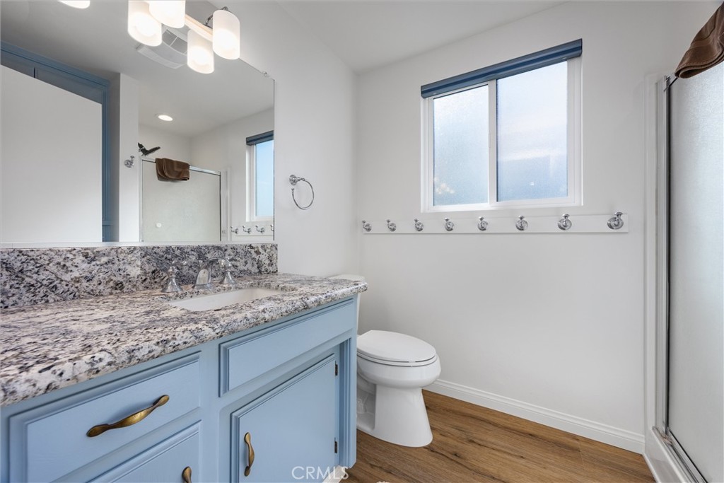 28207 Oaks Rancho Road Keene, CA 93531 - Photo 24 of 48 a bathroom with a granite countertop sink a toilet and mirror