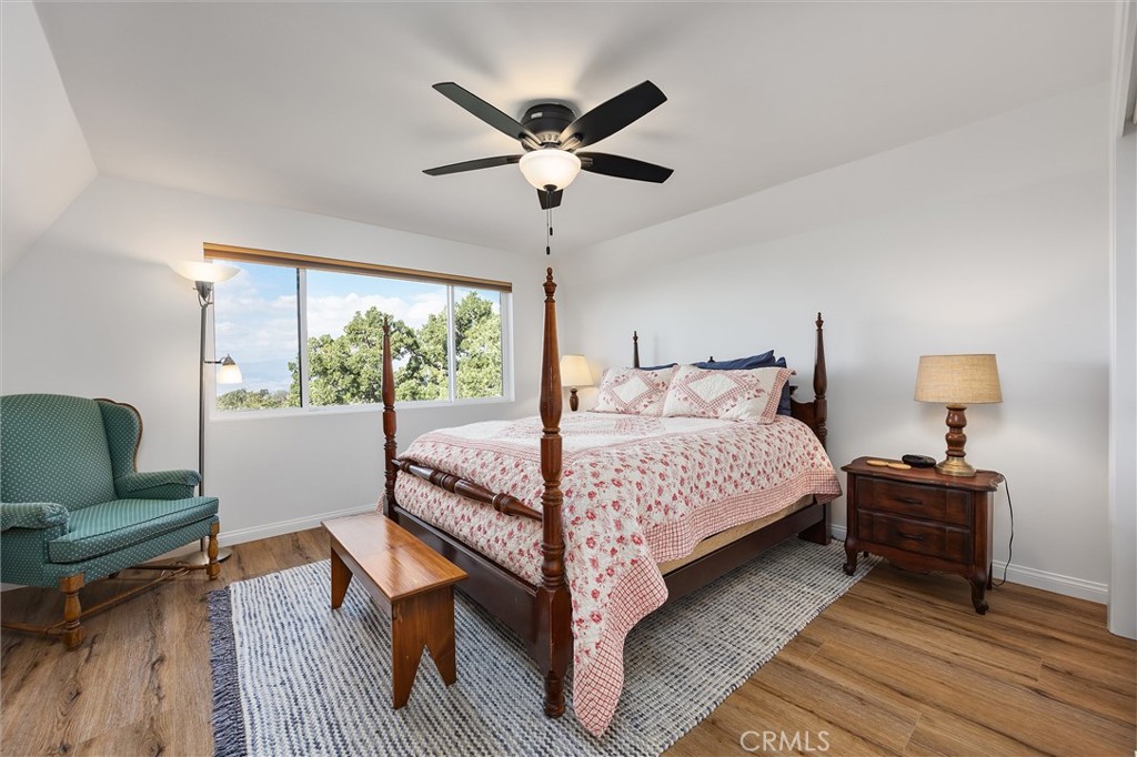 28207 Oaks Rancho Road Keene, CA 93531 - Photo 25 of 48 a bedroom with a bed and wooden floor