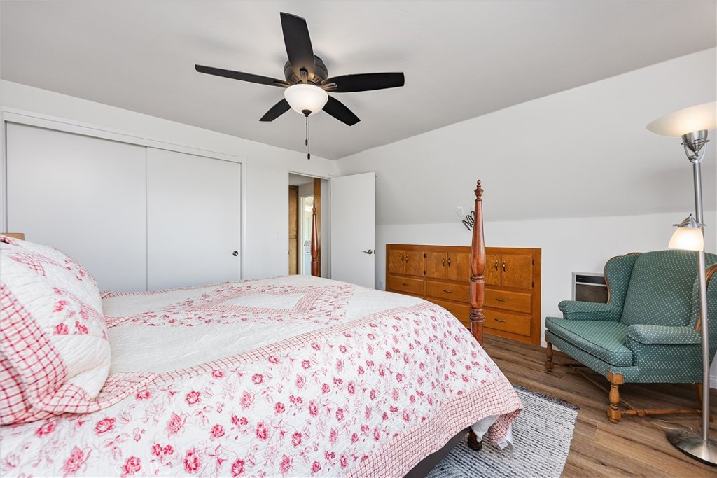 28207 Oaks Rancho Road Keene, CA 93531 - Photo 26 of 48 a bedroom with a bed and a chandelier